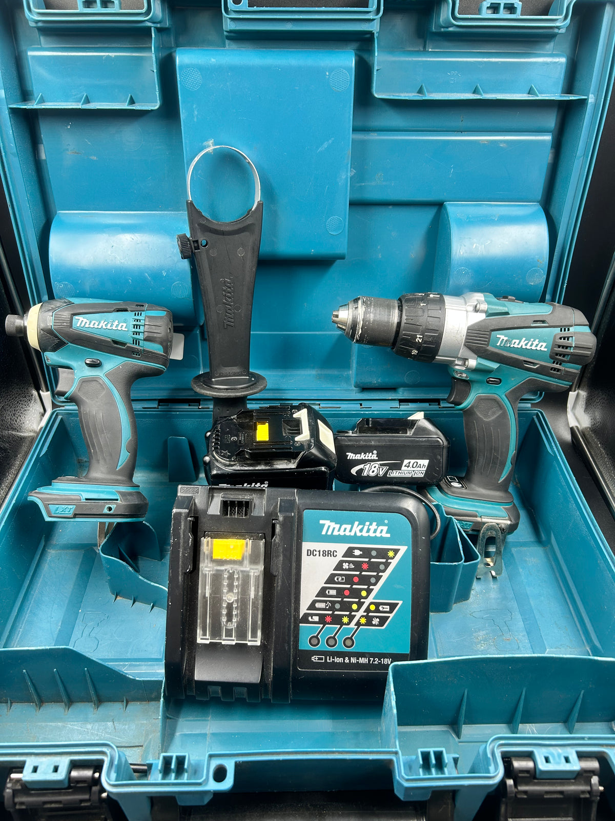 Makita drill driver combo set with x2 4.0ah batteries, charger, grip handle and hard case.